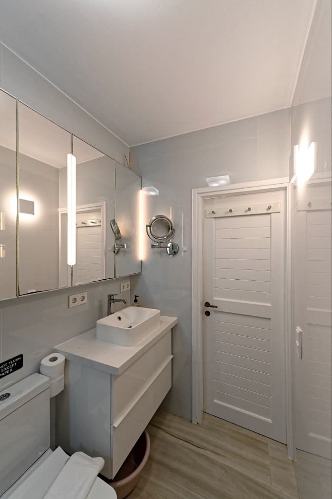 Bathroom vanity, sink and mirrored cabinet at Hedoni Mykonos