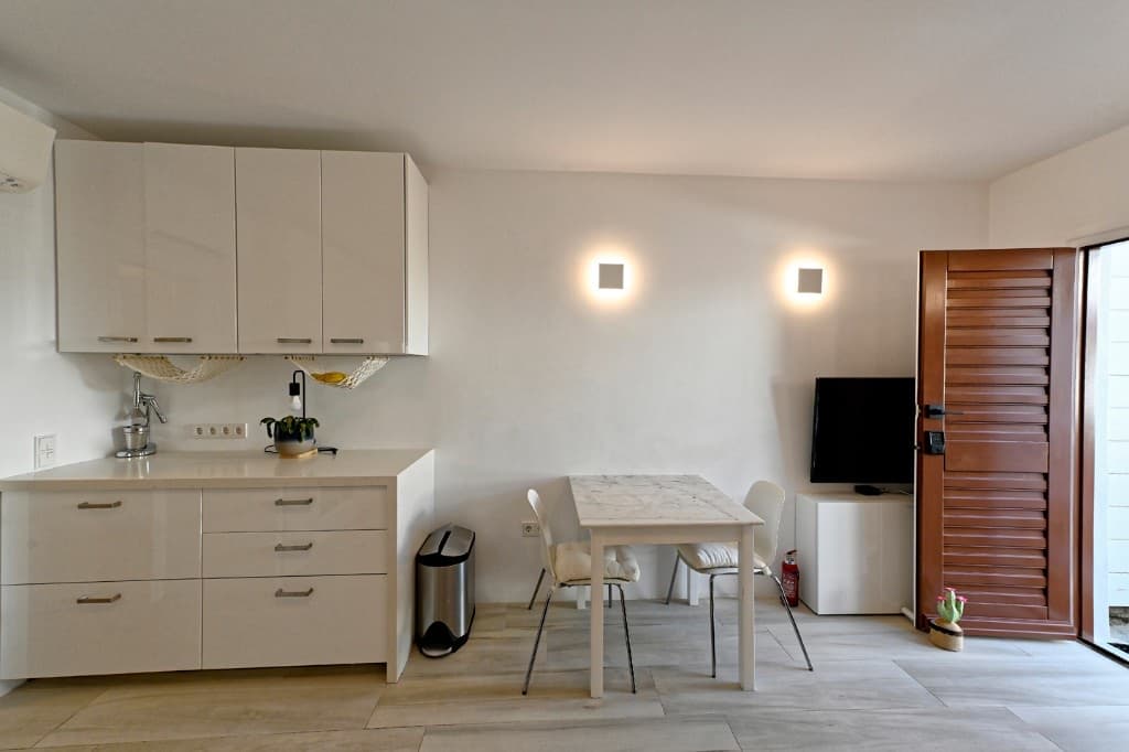 Open-plan kitchen, dining and living area at Hedoni Mykonos